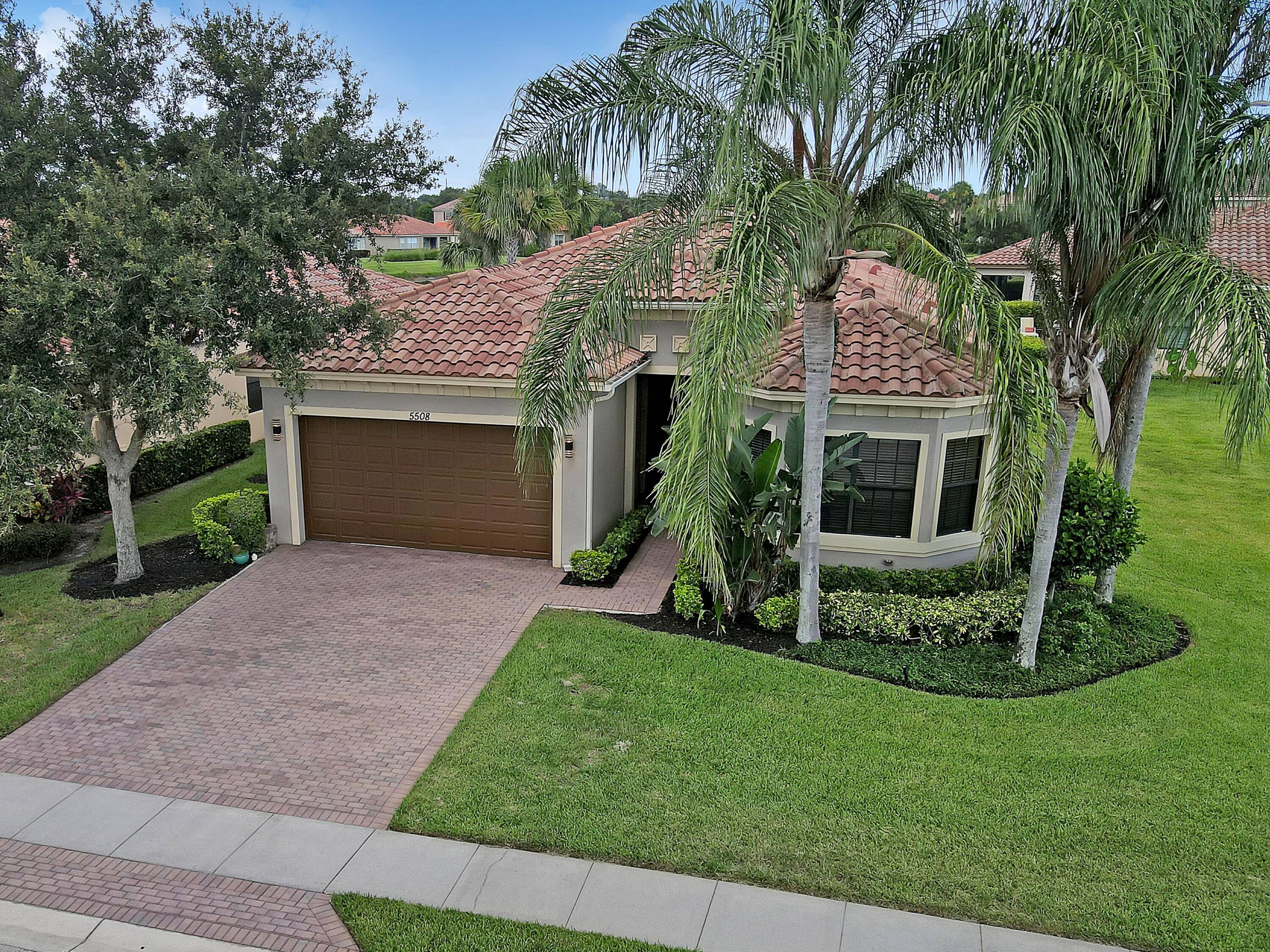 Captivating LAKE VIEW home in the gated Community of VeroLago, a MAINTENANCE FREE Community with LOW HOA fees.
