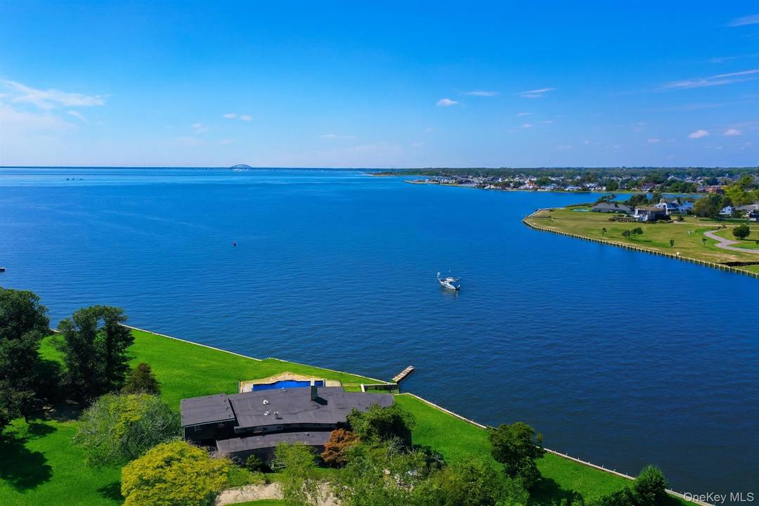 Situated on the point of a private road, this Mid century modern post and beam home is all about peace, privacy, and life on the water.