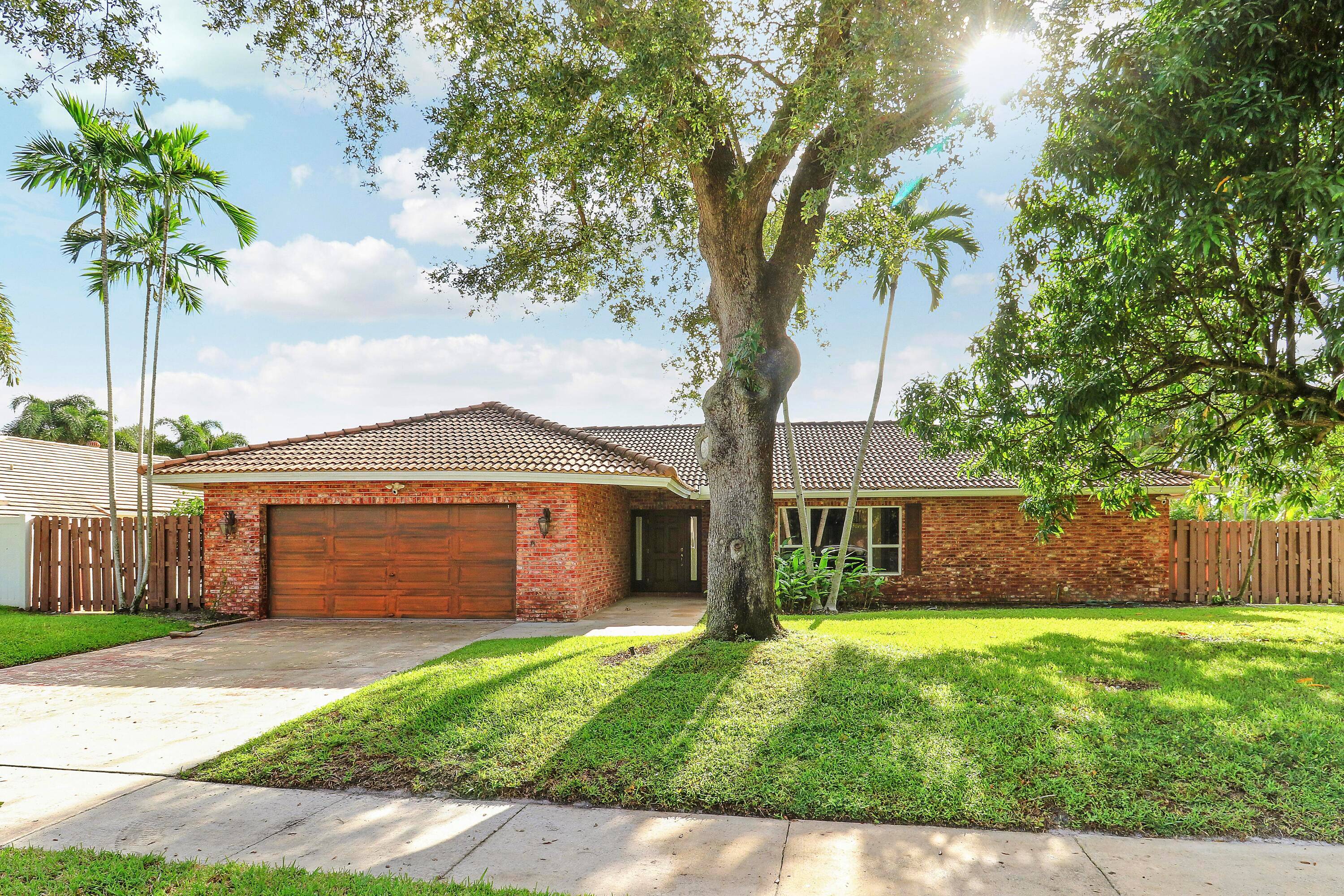 Welcome to your private oasis in the heart of Boca Square, where you will enjoy the freedom of no HOA.