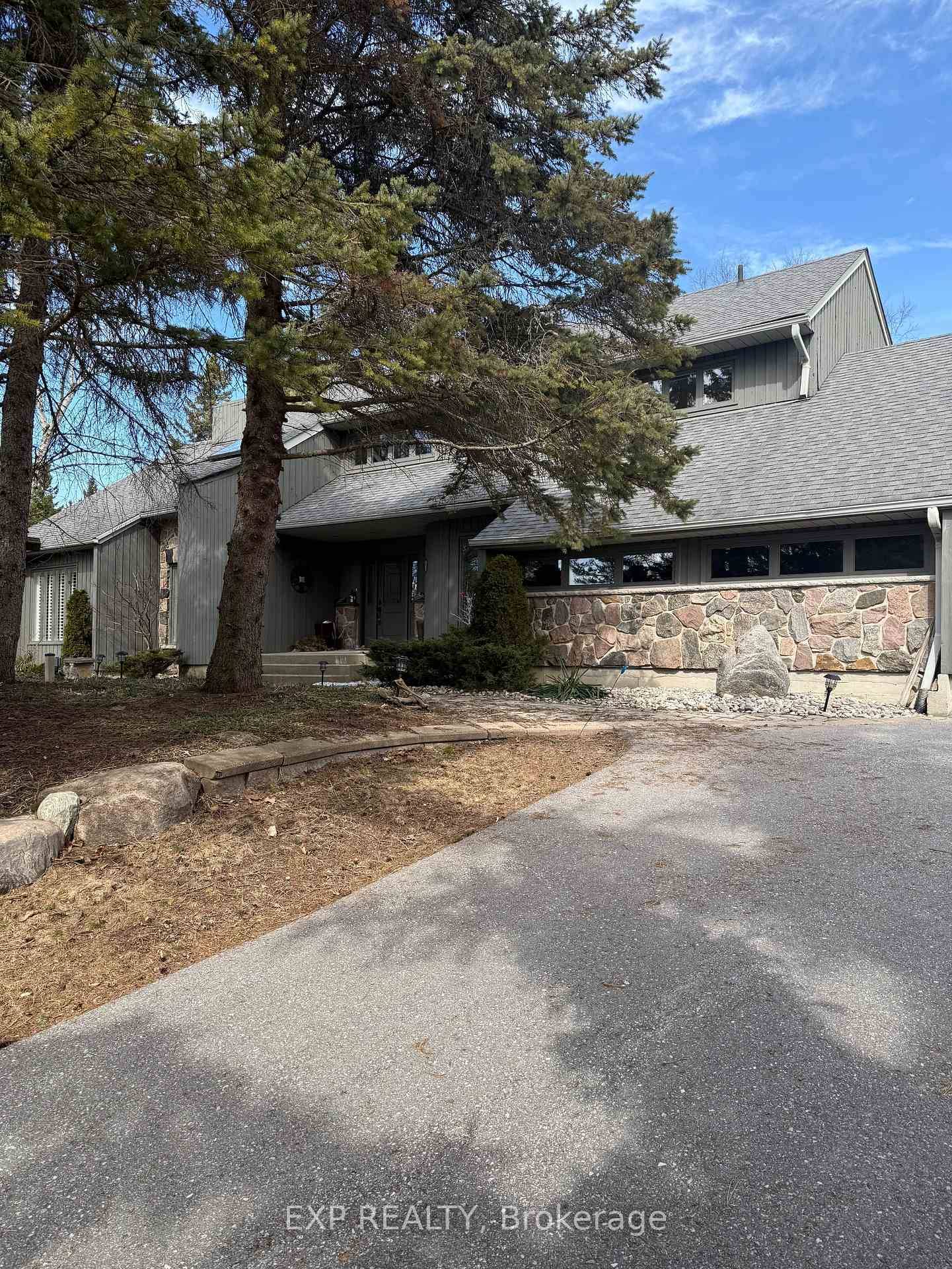 Nestled on a breathtaking treed property with a circular drive, this custom built 2 storey home blends timeless wood and stone exterior with refined, tasteful interiors.