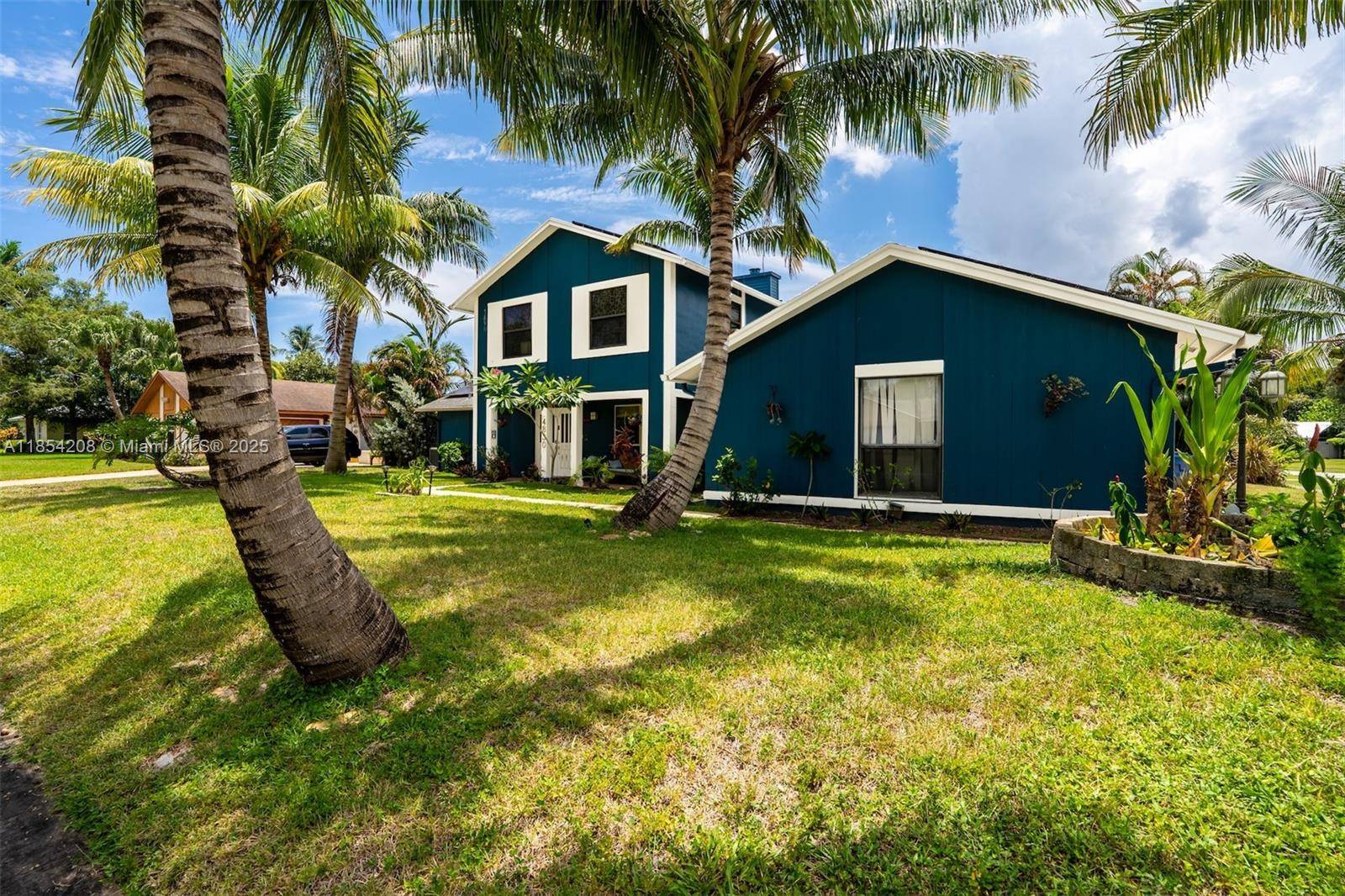 Step into this charming mid century home, perfectly situated on a spacious corner lot in the heart of West Palm Beach.