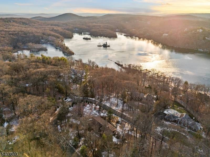 Don't miss this impressive 4 bedroom, 3 full bath Raised Ranch situated in the prestigious Smoke Rise gated community, one of New Jersey's premier lake enclaves.