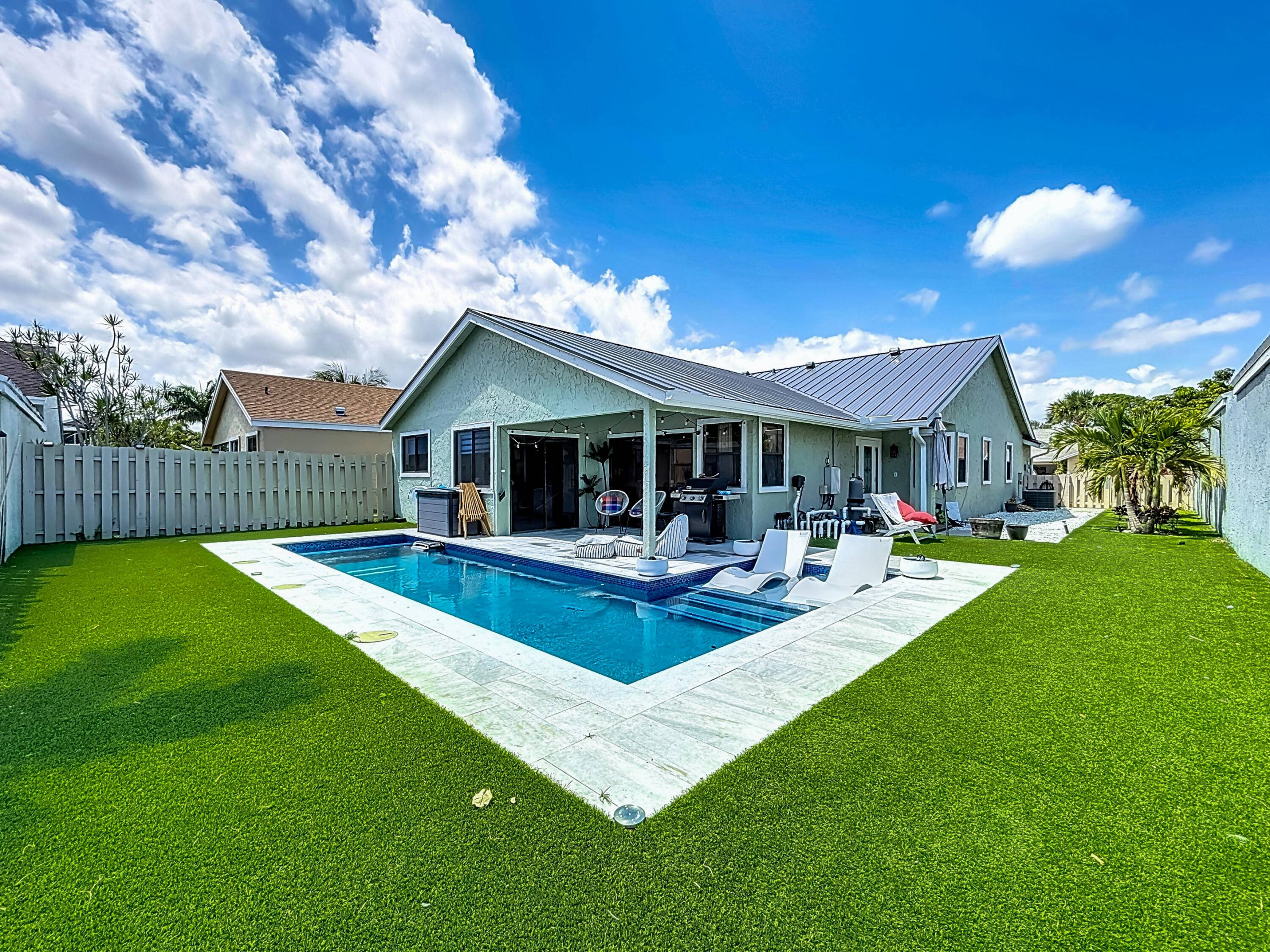LAKEFRONT home in a LOW HOA, GATED COMMUNITY with a NEW PRIVATE POOL, a BRAND NEW METAL ROOF, and new front yard landscaping.