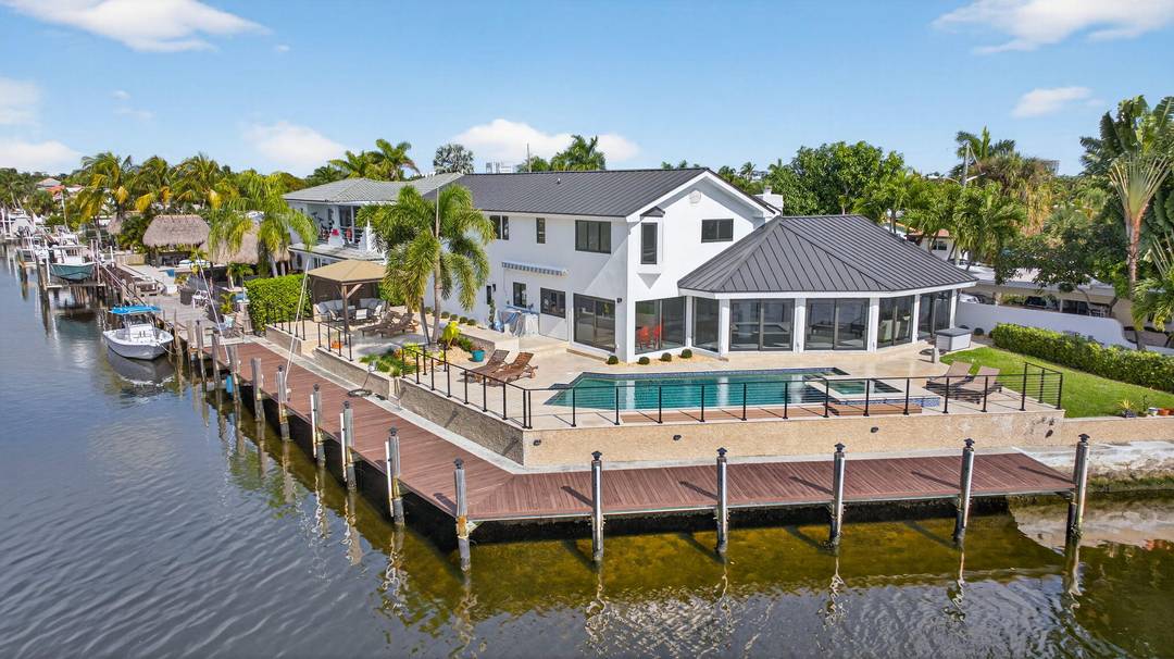 Rare point lot with almost 200 feet of waterfront and dock less than two miles from the beach !