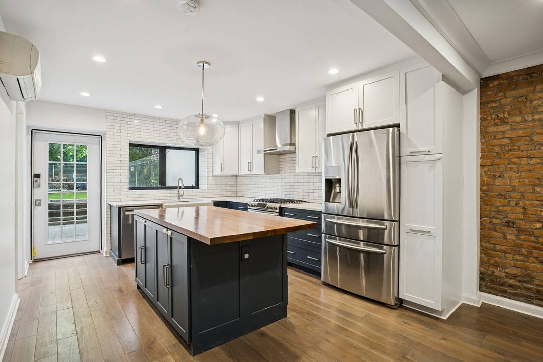 Welcome to 445 Franklin Avenue, a beautifully reimagined townhouse triplex that artfully balances historic charm with modern style.