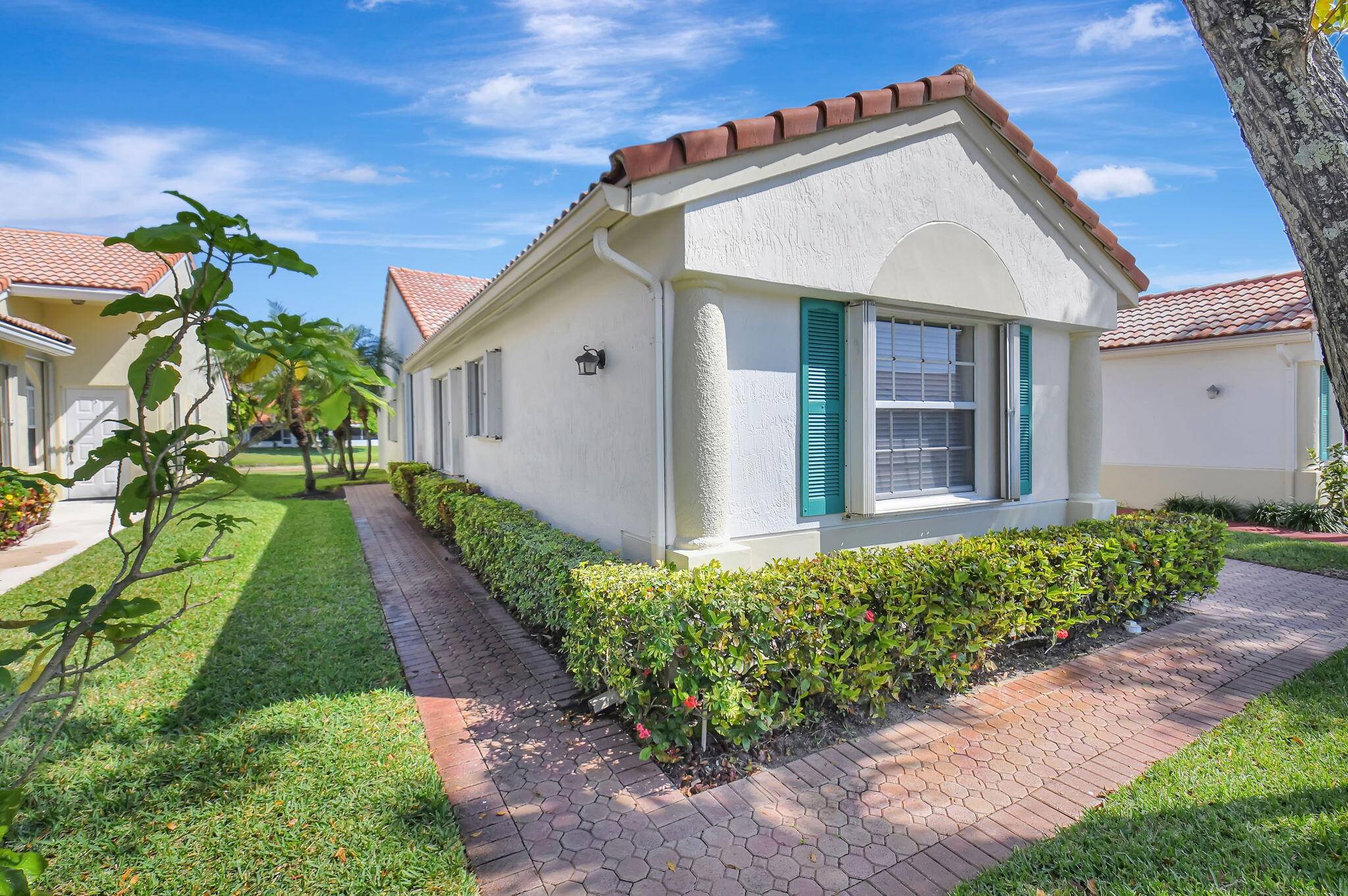 Spacious 1 story 3 bedroom, 2 bathroom, corner villa with peaceful lake views in the highly sought after 55 Community Floral Lakes.
