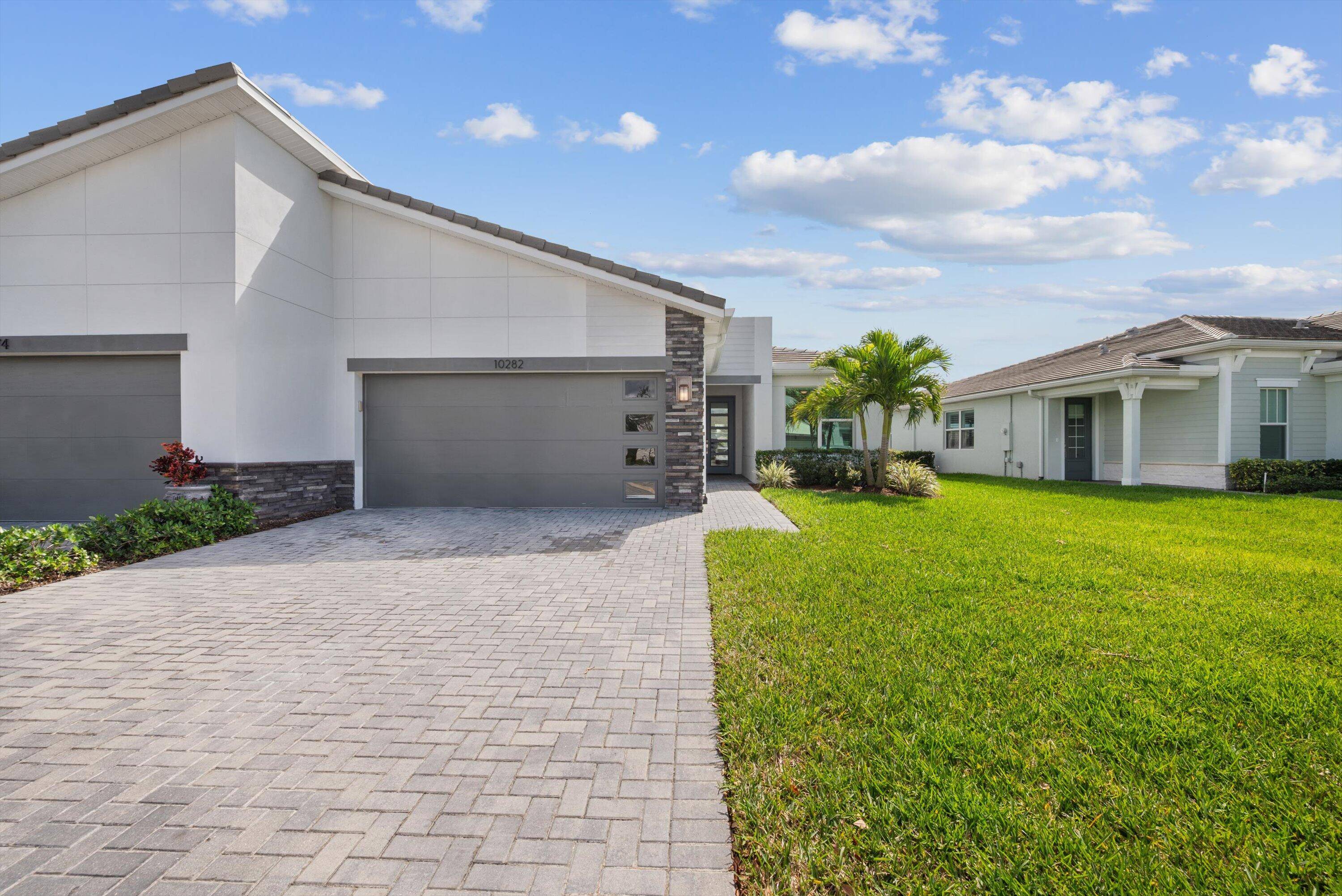 Located in the GATED Telaro at Southern Grove, this NEWER construction BARELY LIVED in villa offers stunning LAKEFRONT views and a low maintenance lifestyle.