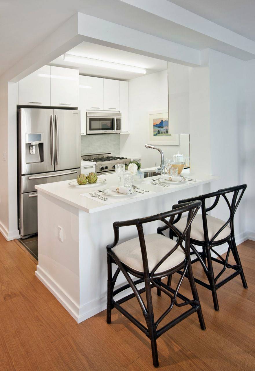 Bright one bedroom with over sized windows showcasing open views across Broadway.