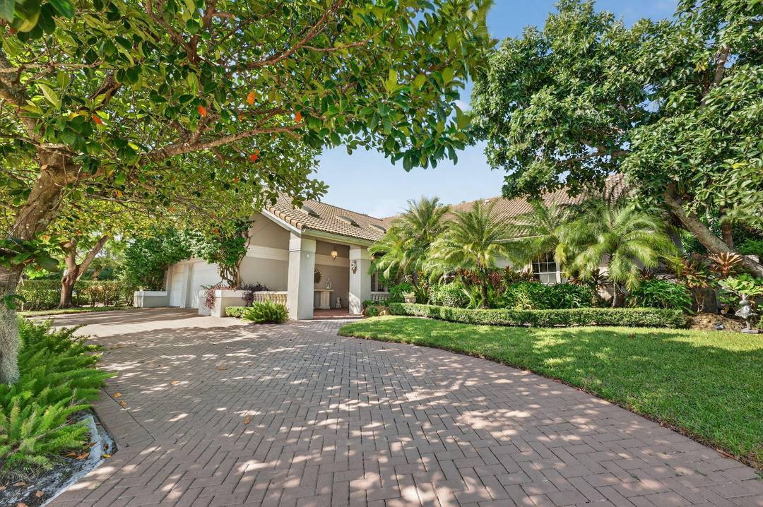 Tropical Oasis awaits ! Welcome to your beautiful updated 4 bedroom 4 bath home in Boca Grove Golf Club.