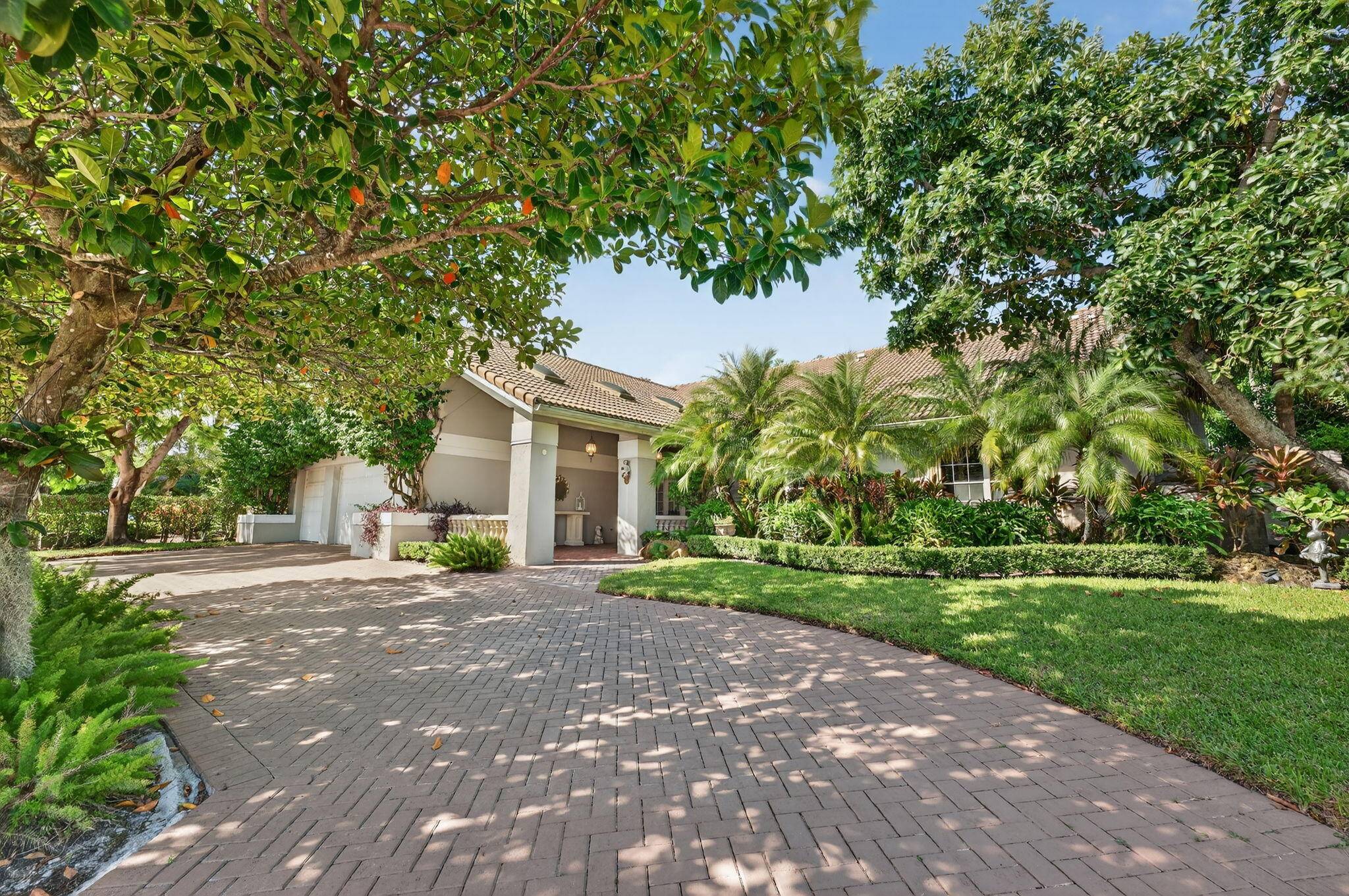 Tropical Oasis awaits ! Welcome to your beautiful updated 4 bedroom 4 bath home in Boca Grove Golf Club.