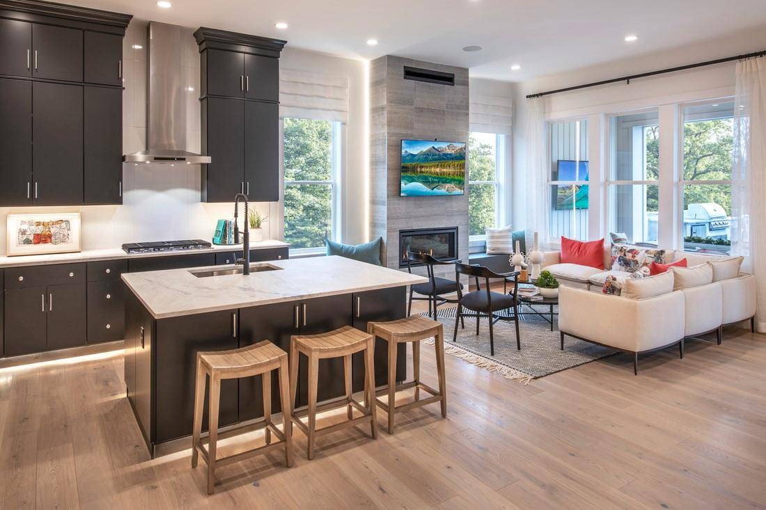 A welcoming foyer punctuated by a tray ceiling leads past a versatile flex room into the main living area, featuring an elegant dining room and a spacious great room.