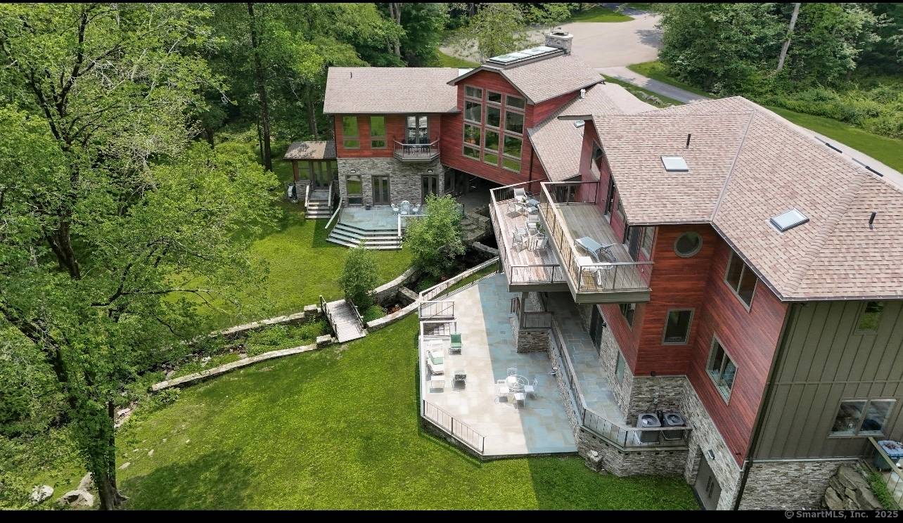 Mid Century Modern Inspired Turnkey Connecticut Contemporary Design influenced by the works of Frank Lloyd Wright and Philip Johnson Including spacious indoor outdoor living, more than 100 picture windows, skylights, ...