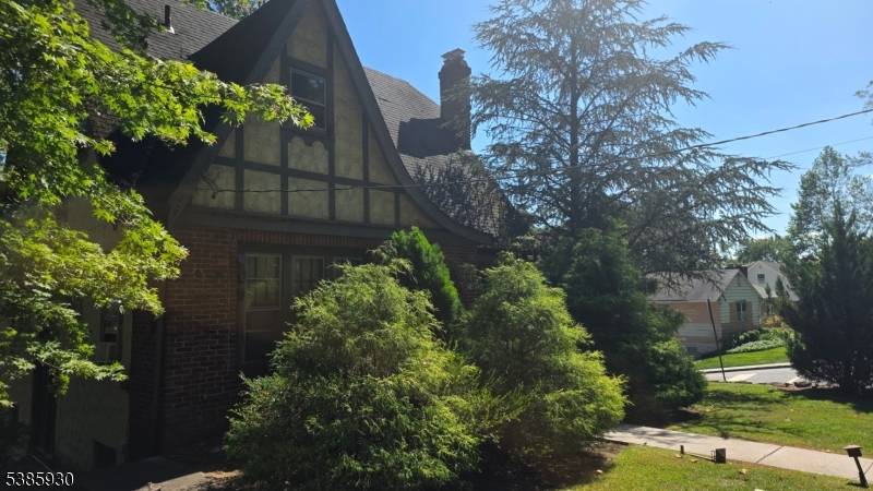 Welcome to this well maintained Tudor style home, perfectly situated on a spacious double lot.