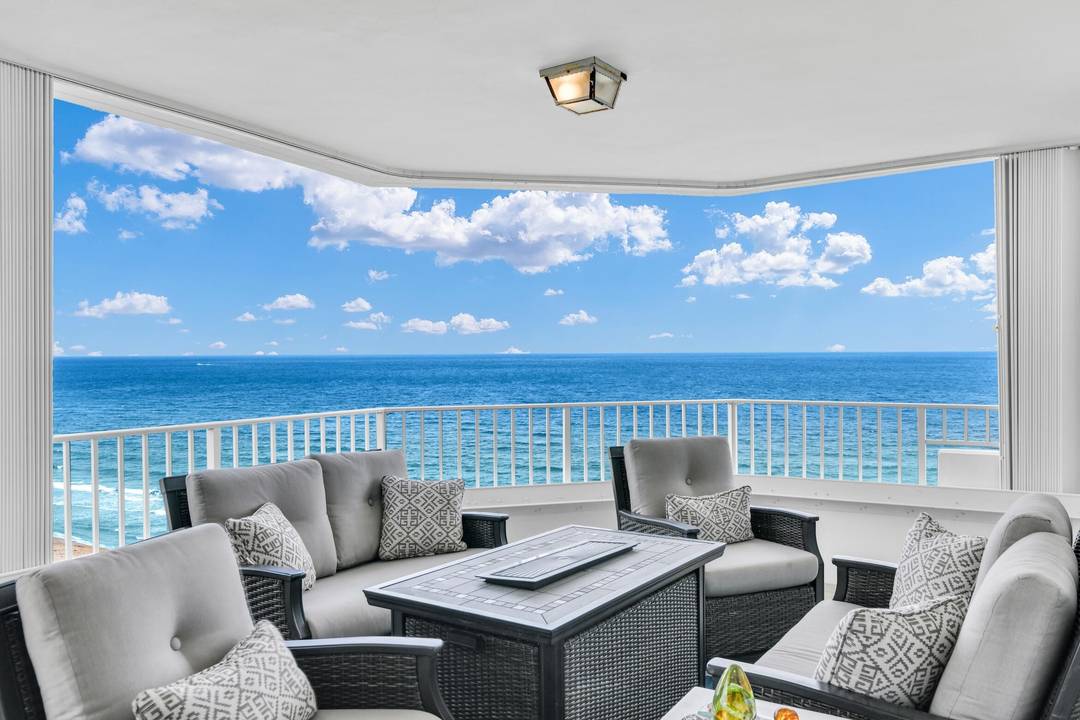 Experience stunning wraparound views from this corner residence in Boca Raton's premier oceanfront location.