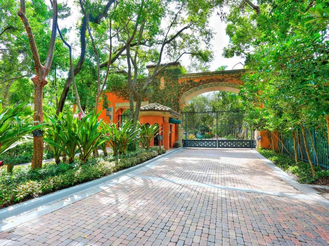 Experience refined waterfront living in this exceptional villa at the prestigious Cloisters on the Bay in Coconut Grove.