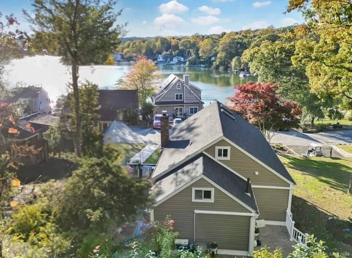 Welcome to this beautifully remodeled year round lake home offering breathtaking views overlooking the shimmering waters of Lake Pocotopaug.