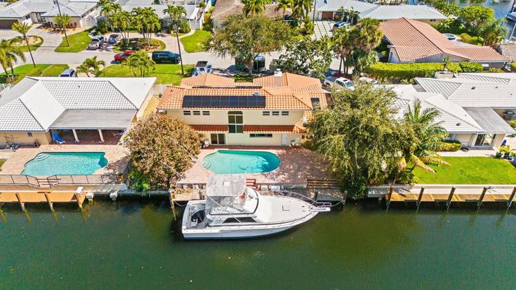 80 feet of deep water frontage, no fixed bridges, and just around the corner from Hillsboro Inlet, a boater's DREAM.