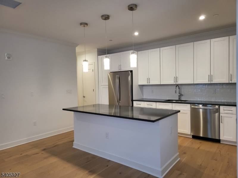 Commuters Dream ! Luxury Multilevel Townhouse across from Bloomfield Train Station with direct service to New York PennStation less than a 30 minute commute.