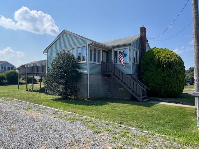 Ranch style home with 2 beds, 2 baths, kitchen, dining area, living area and an enclosed porch being used as a family room.
