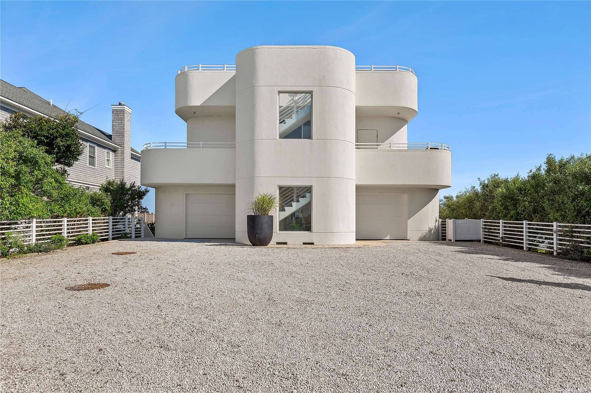 This elegant, sleek, three level Dune Rd bayfront contemporary has panoramic views of the ocean and bay from the rooftop outdoor entertaining area, ocean and bay views from the second ...