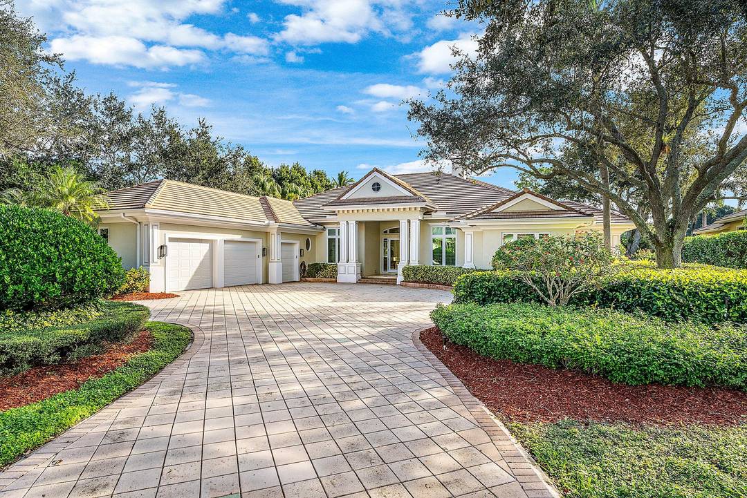 Fabulous custom home sited on a half acre lot with dramatic water and golf views in prestigious Old Marsh Golf Club.
