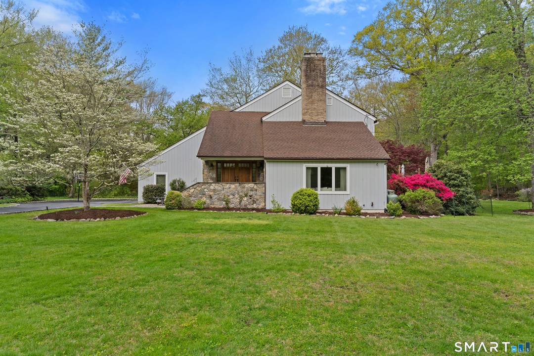 Set on a sunny acre well back from the street, this beautifully maintained and thoughtfully updated 4 bedroom, 2.