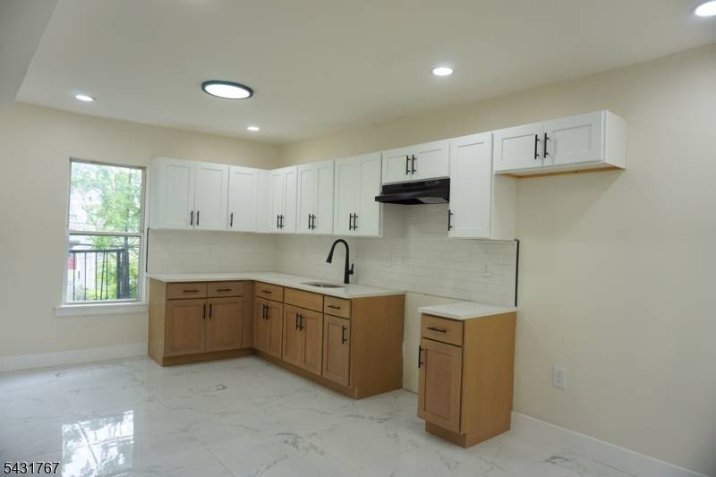 Welcome to this beautifully renovated two family home nestled on a quiet, well kept block in the heart of East Orange.