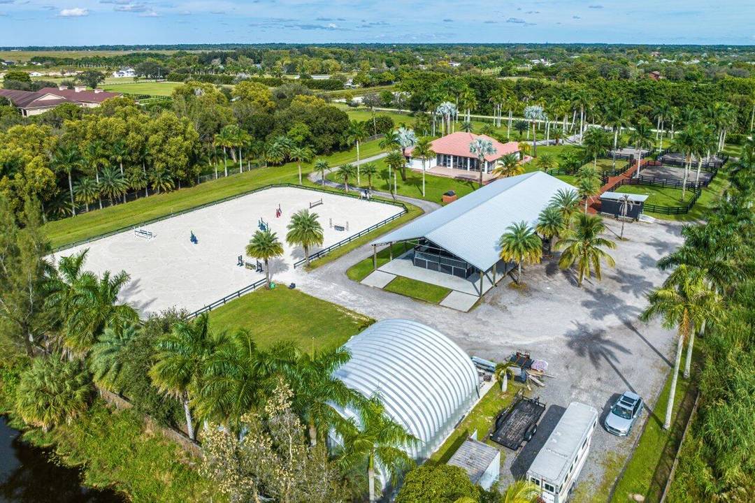 Barn with studio lounge, tack room, feed room, 4 covered wash stalls w fans, RV hookups.