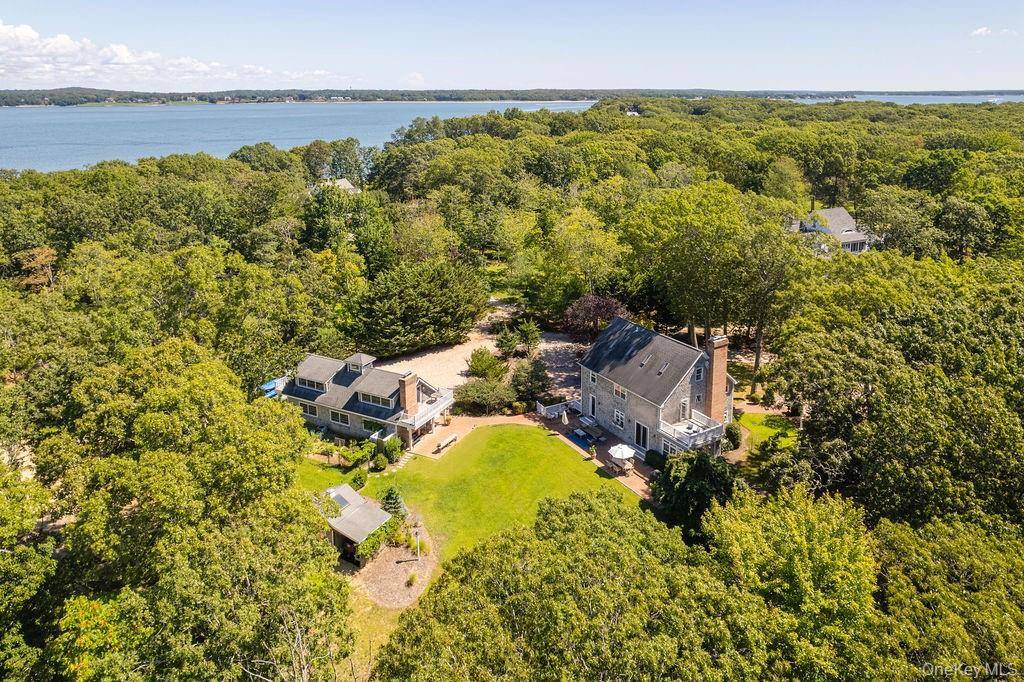 Set on over two secluded acres within the coveted Shellfisher Preserve association near Paradise Point, this extraordinary estate offers sweeping water views from the backyard, kitchen, and upstairs rooms.