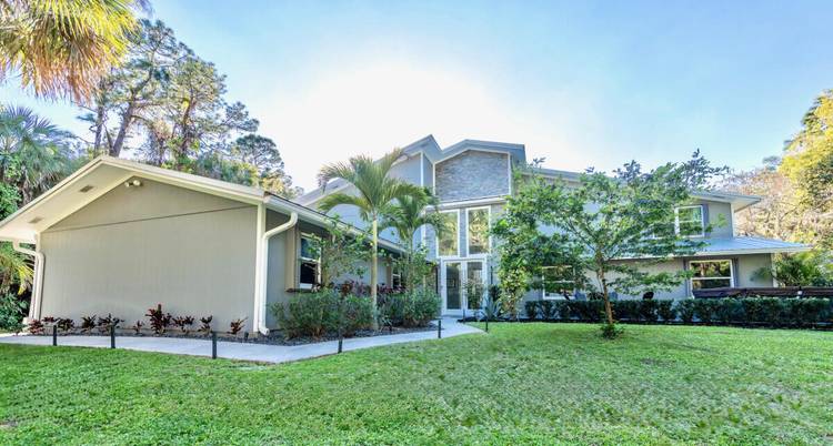 LOCATION, LOCATION ! Situated on the highly desirable northeast corner of Jupiter Farms, this exceptional property offers the perfect balance of privacy, convenience, and lifestyle.