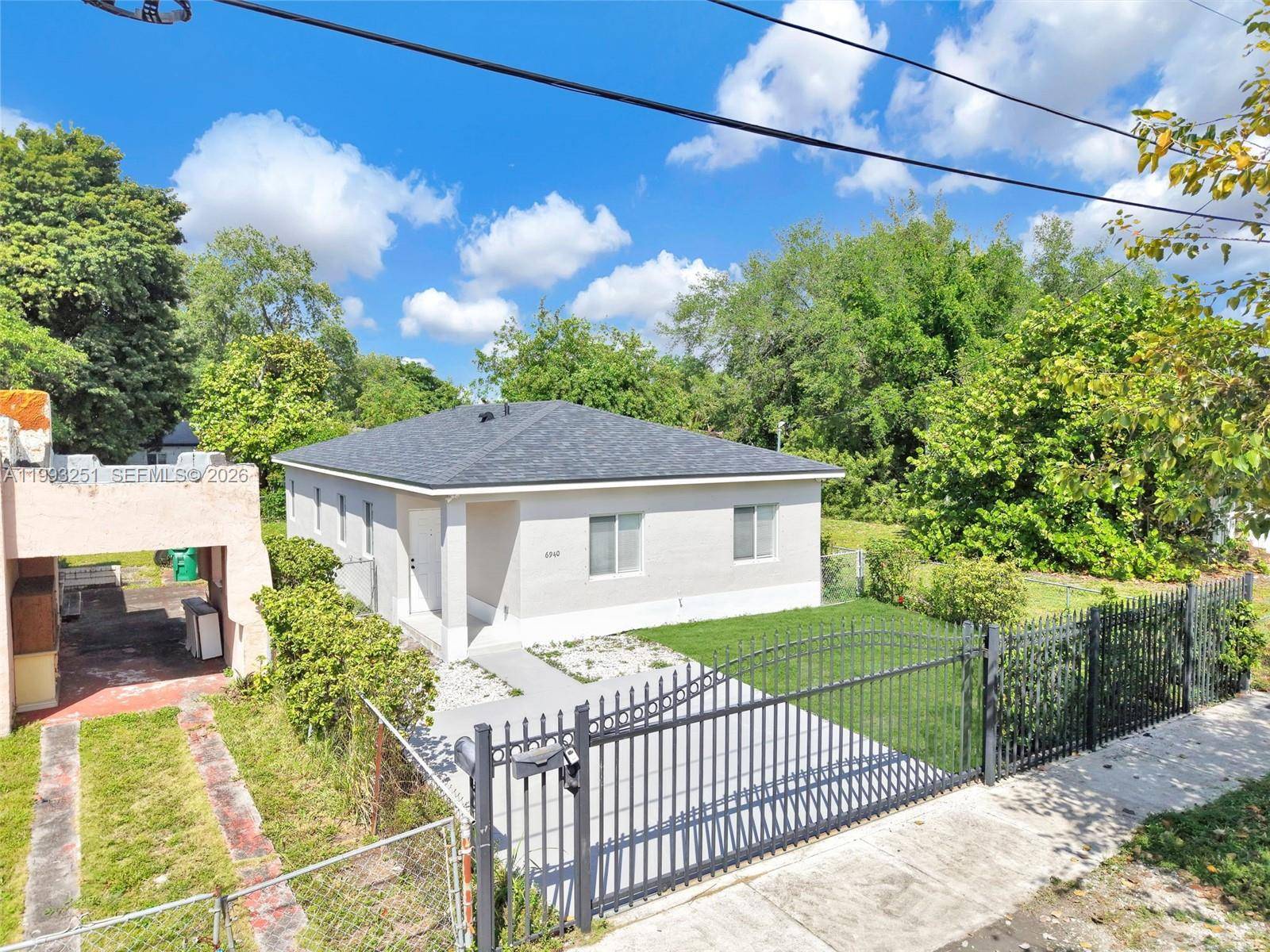 In the heart of Miami, this gated home built in 2005 features a brand new roof for added peace of mind.