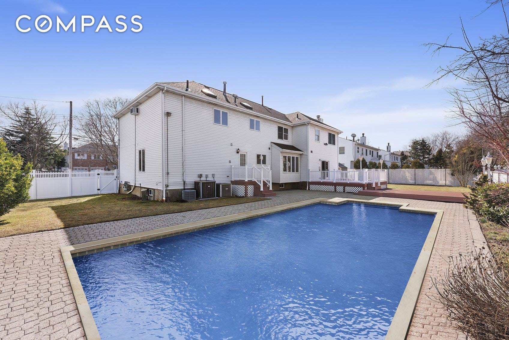 Stunning 2 family center hall colonial sitting on a wide, tree lined street surrounded by luxurious homes.