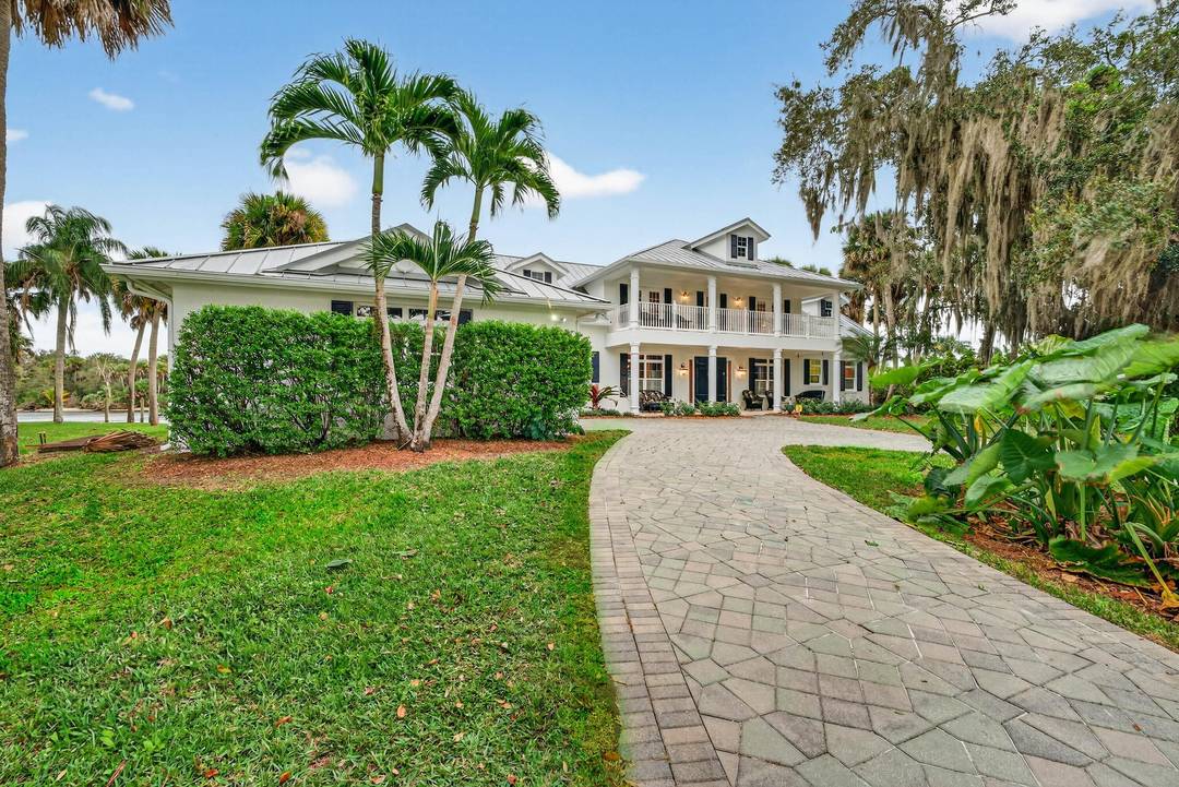 Welcome to Imagination Plantation, a 5 bedroom, 4 bath waterfront estate on 4 acres in Palm City including a 3 acre vacant buildable lot fronting the main residence.
