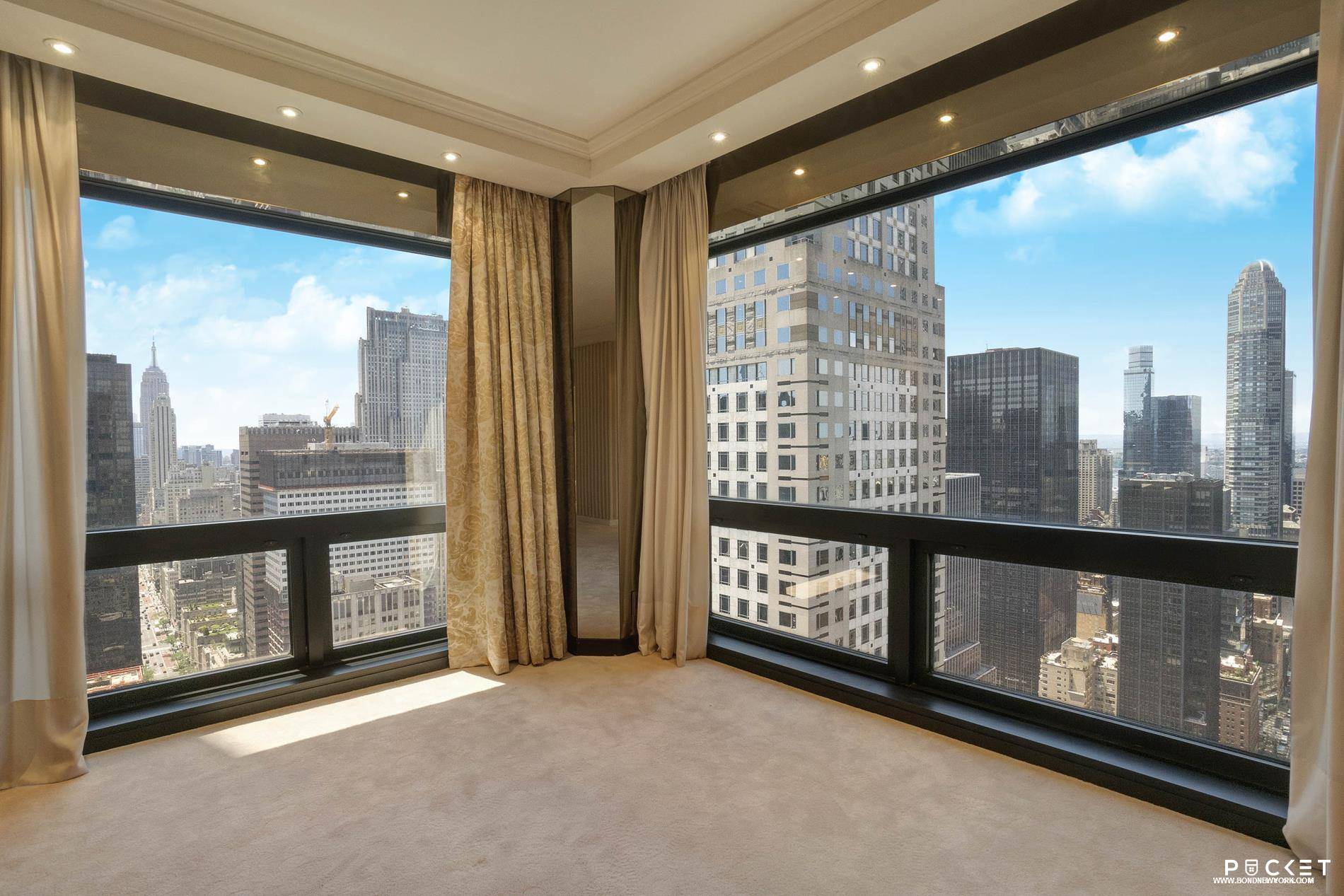 Spectacular views from this 52nd floor apartment looking south over Fifth Avenue, Empire State and Chrysler buildings and west over the Crown Building toward the Hudson River and beyond.