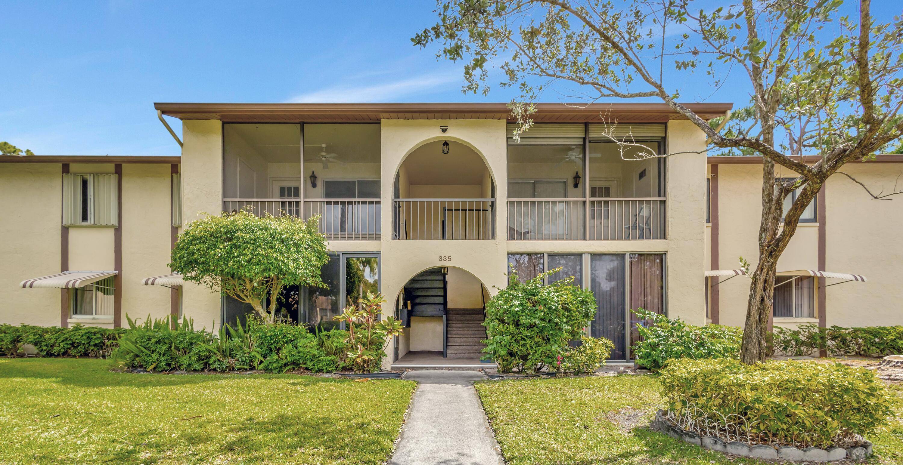 Spacious, move in ready 1st floor Condo with 2 bedrooms, 2 bathrooms, enclosed front porch w impact glass sliding door storage.