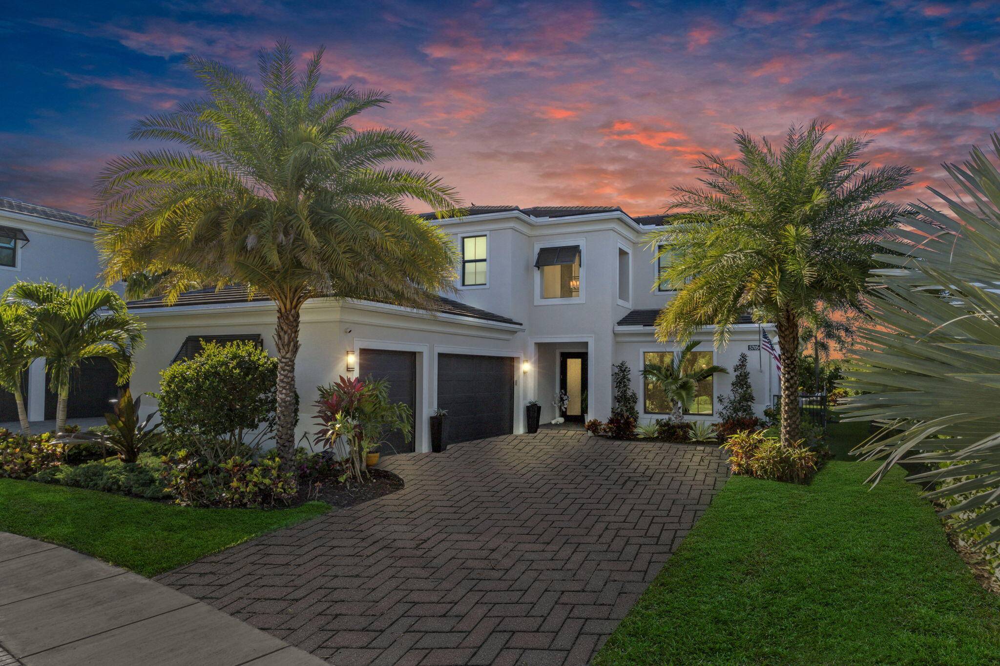 Step into this extraordinary 4 bedroom, 5 bathroom lakefront estate, located in this prestigious Palm Beach County gated community.