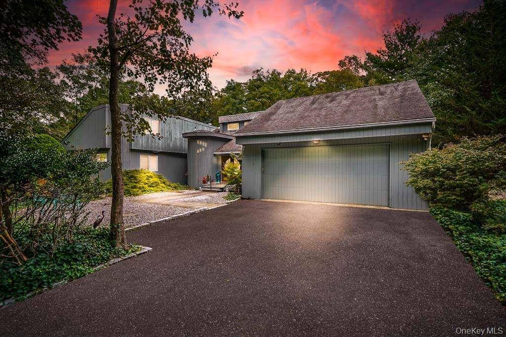 Welcome to this exceptional Fort Salonga residence offering over 4, 000 sq ft of living space on a private, wooded acre.