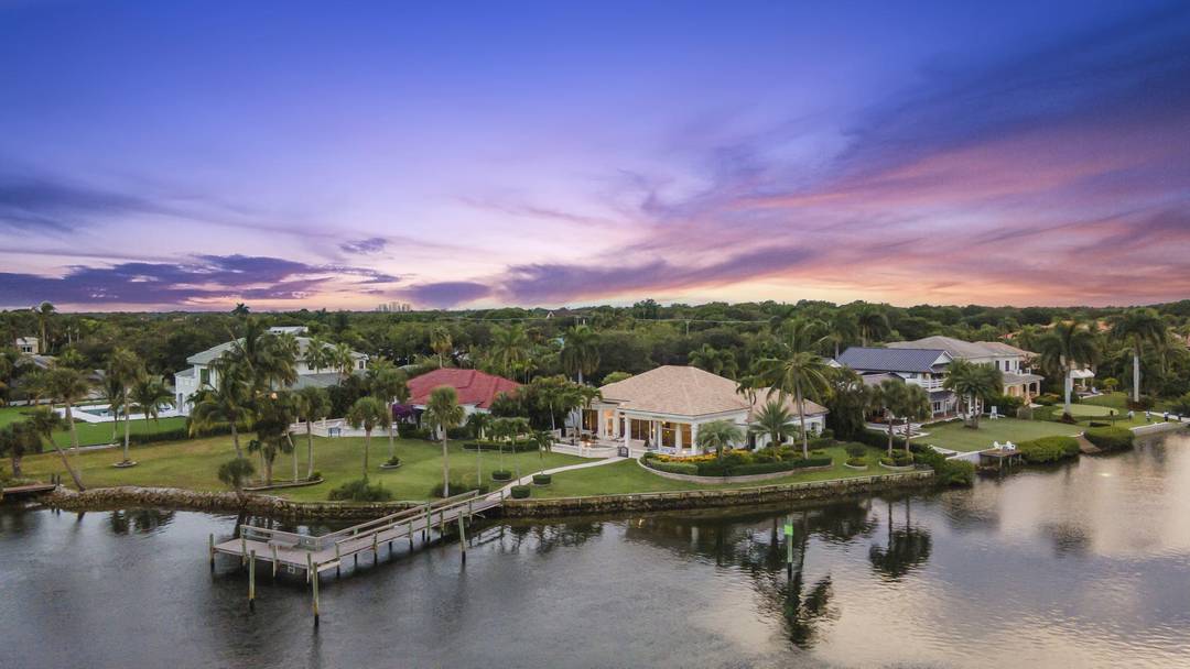 Exceptional waterfront property in a gated Palm Beach Gardens community with 230 feet of direct Intracoastal frontage and wide water views.