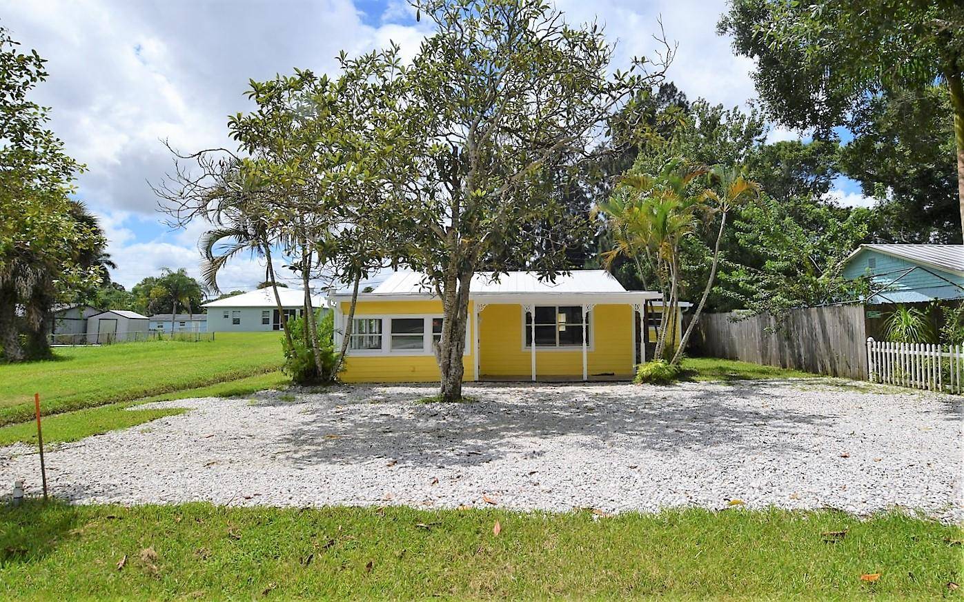 Discover this Key West style home bursting with charm, character unbeatable curb appeal.