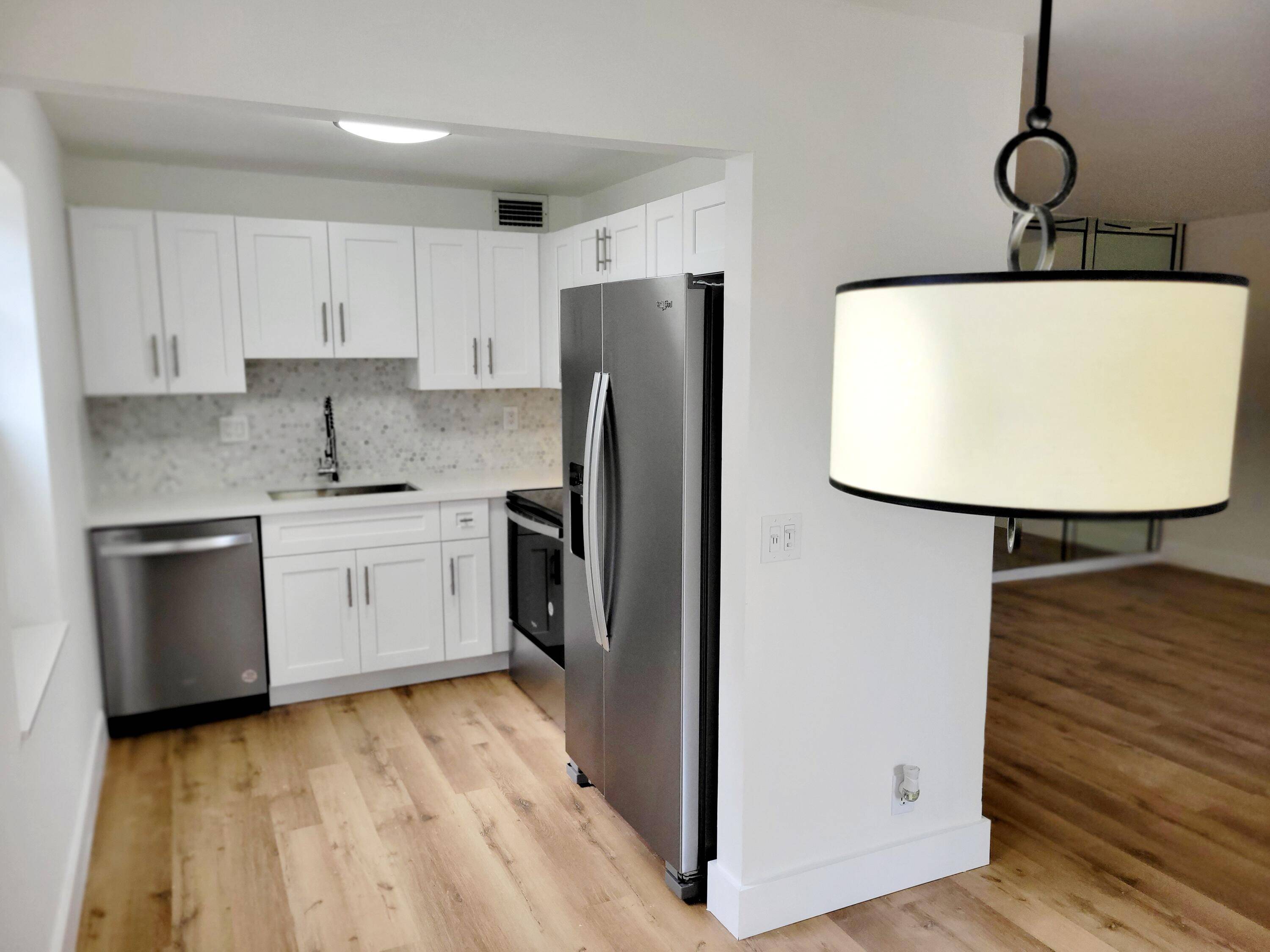 PRICE REDUCTION ! !.. Newly renovated 1st floor condo with all new stainless Whirlpool appliances, 3 4 inch solid shaker cabinets with white quartz counters.