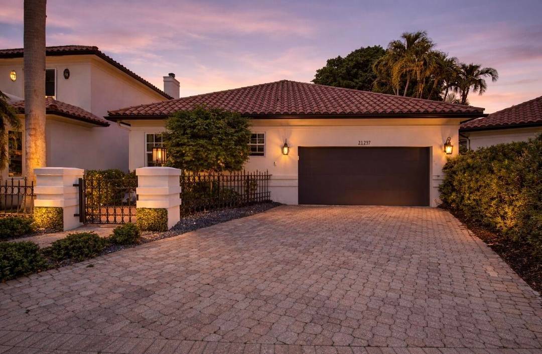 Welcome to this exceptional residence nestled within the prestigious Boca Grove community.