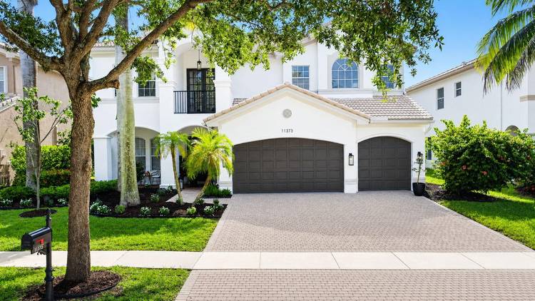 Masterfully renovated 6 bedroom, 4 bathroom two story home flooded with light and perfectly positioned for unparalleled western exposure sunsets framed by mature trees and privacy hedges overlooking the lake.