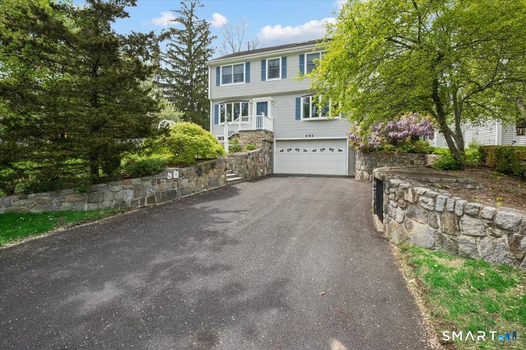 This immaculate updated colonial home features a beautifully landscaped yard and an oversized 4 car garage.