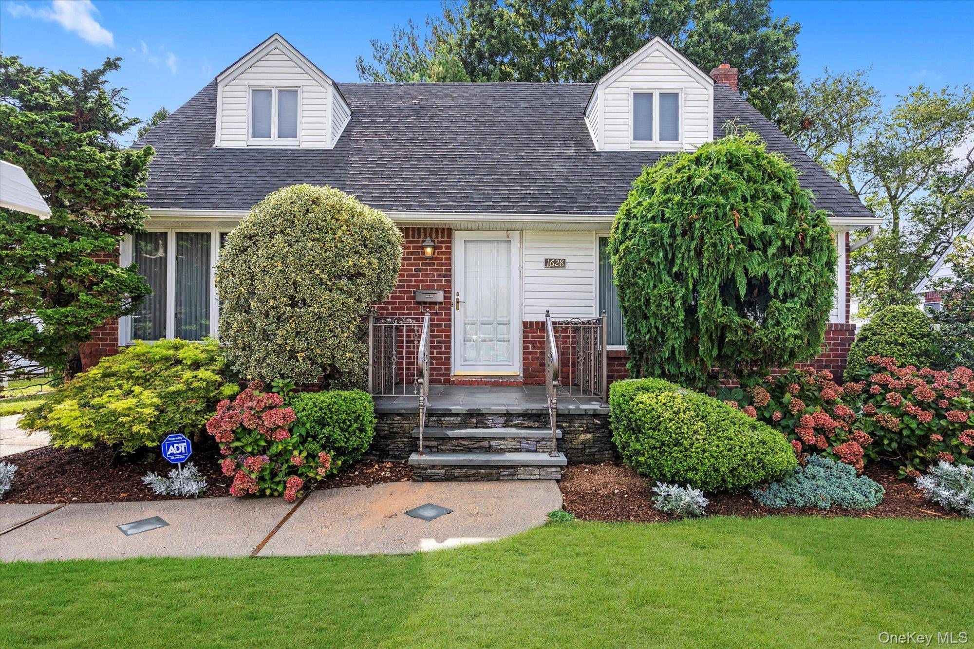 Charming Cape Cod located in the prestigious Barnum Woods section of East Meadow.