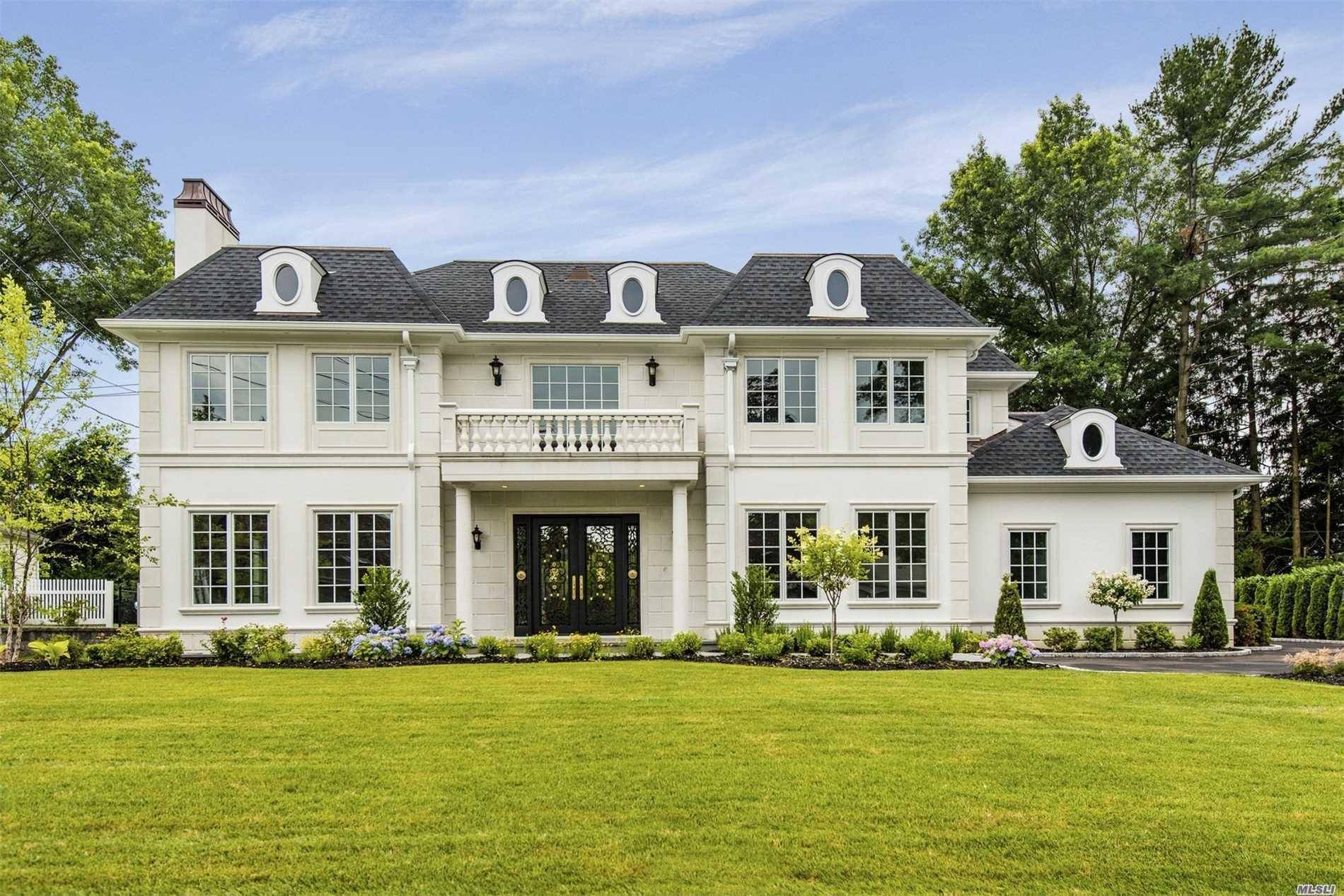 Located in the coveted Village of Flower Hill, this custom built 6 bedroom, 4.