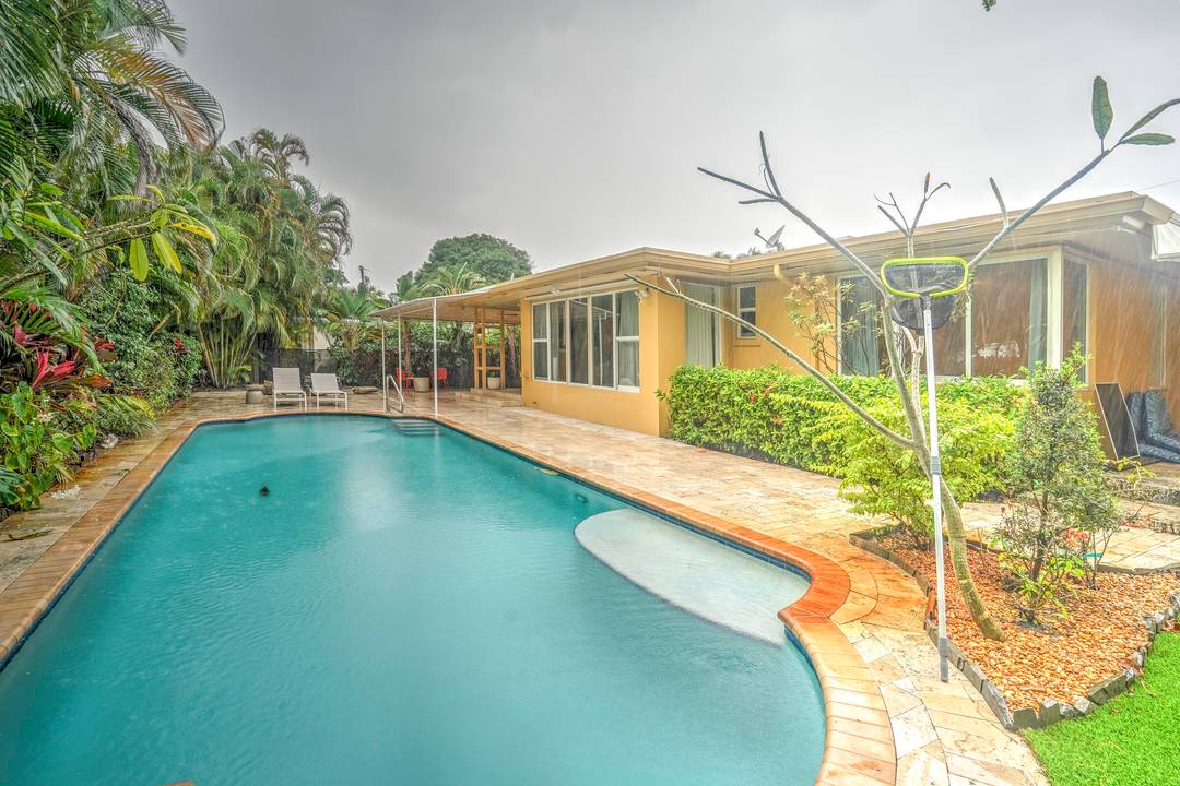 Mid century pool home with 3 bedrooms, 3 baths and a 42' resort style pool in Northwood Shores, just steps from the Intracoastal.