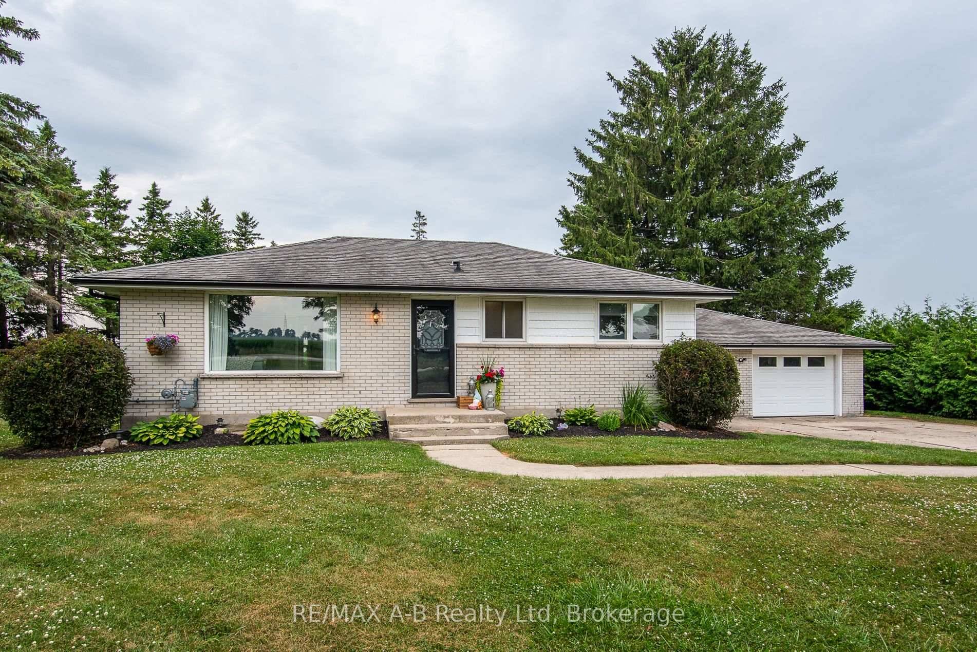 Welcome to this beautifully maintained bungalow nestled on a tranquil 3 4 acre country lot, backing onto picturesque farmland.