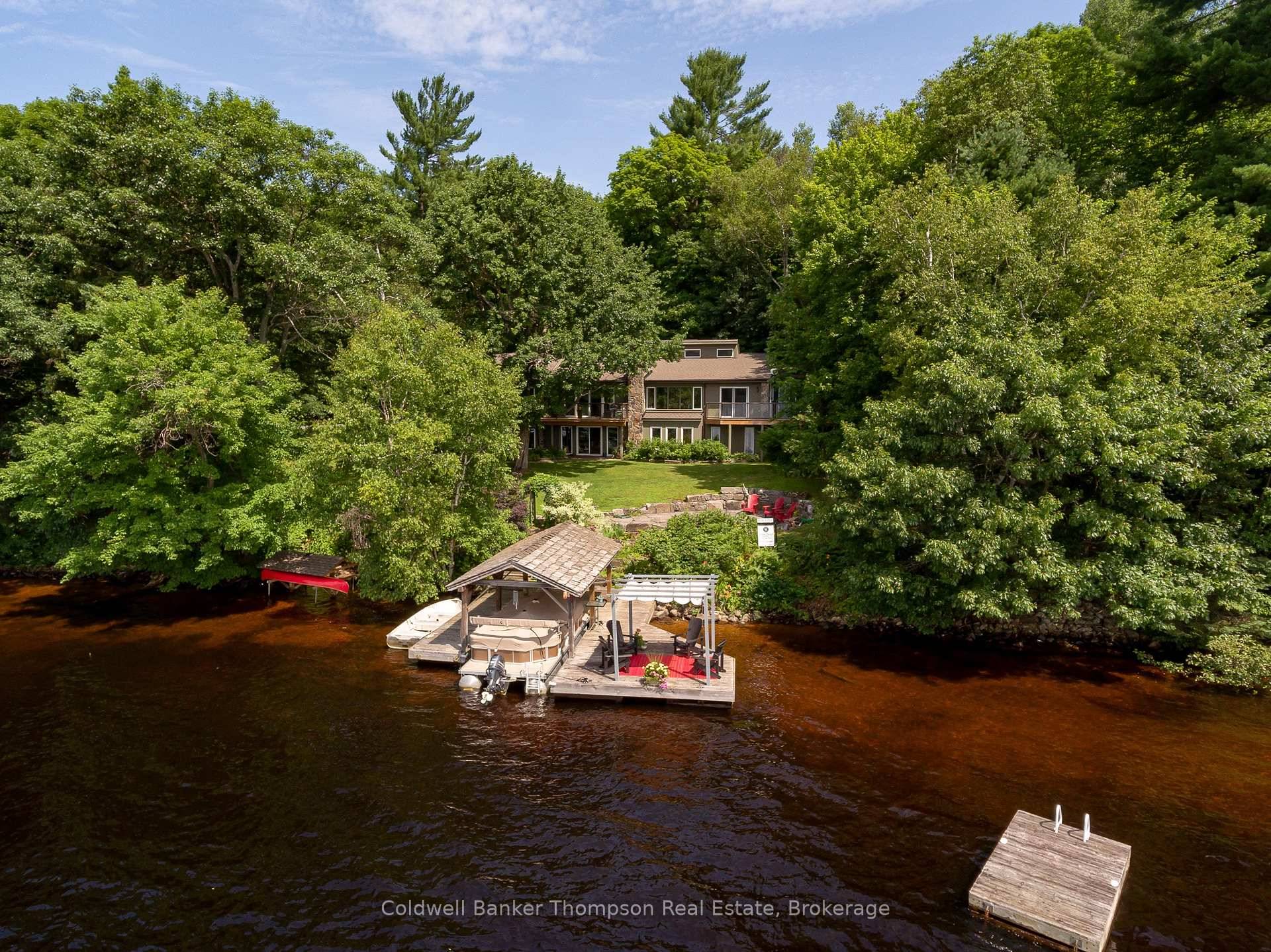 FRESHLY RENOVATED Impressive year round home or cottage resting on one of the most desirable park like properties on Lake Vernon, with 1.