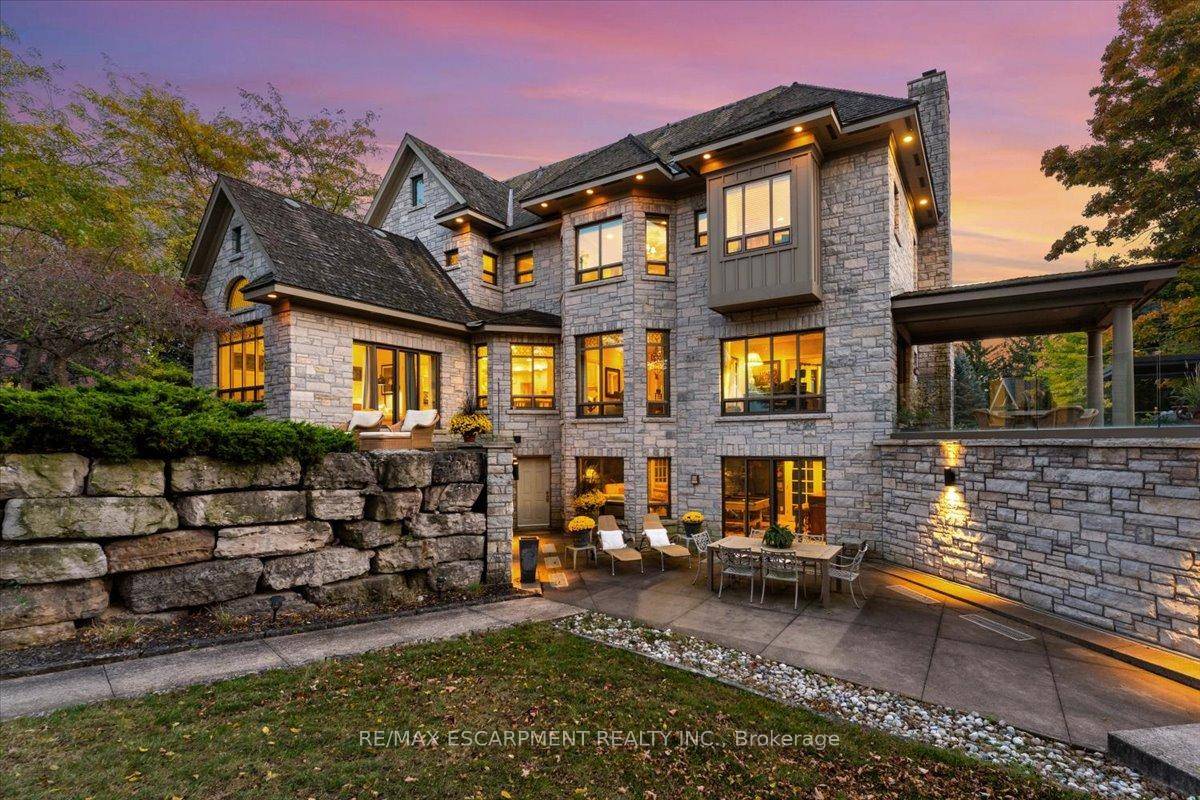 Set on the Niagara Escarpment with panoramic views of Lake Ontario, Beamer Falls, and a scenic river, this elegant retreat offers refined living.