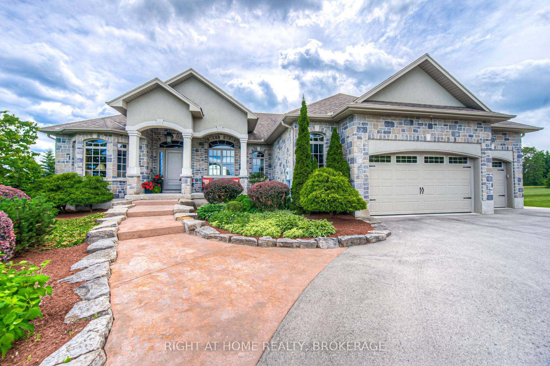 Welcome to this breathtaking custom built bungalow, nestled on a beautifully treed, nearly 4 acre lot.